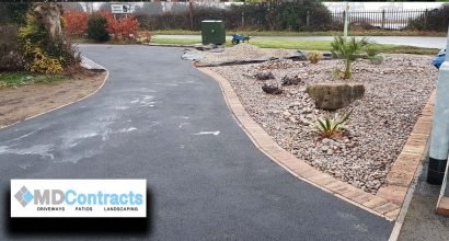 Gravel landscaping and tarmac driveway.